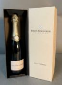 A bottle of Louis Roederer brut premier champagne in original box