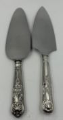 Two cake slices one with a hallmarked silver handle.