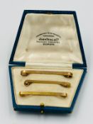 A selection of three 9ct gold tie clips with a combined approximate weight of 7.4g