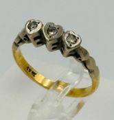 An 18ct three stone heart themed diamond ring with an approximate weight of 3g and size L