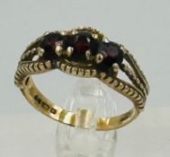 A 9ct gold ring set with garnets, approximate weight 2.7g and size N.5