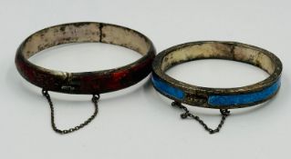 Two silver and enamel bangles, one blue, one red with floriate design.