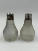 A pair of lightbulb themed salt and pepper pots in frosted glass with hallmarked silver screw tops