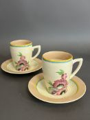 Two Clarice Cliff Lynton shape coffee cups and saucers with floral pattern