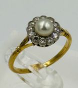 An 18ct gold daisy style ring with pearl and diamonds, approximate size N.5 and weight 2.4g
