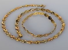 An Italian tri-gold necklace and matching bracelet by Periamma, both stamped 750, 29g