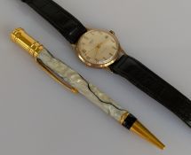 A vintage Smiths manual wristwatch with Arabic numerals on a champagne dial, date aperture