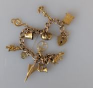 A yellow gold charm bracelet, two charms 18ct, 2.5g, one 14ct, 2g, chain and others 9ct, 23g