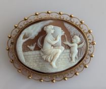 An oval cameo brooch with raised classical scene in a pierced 9ct gold frame, 50 x 60mm, hallmarked
