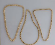 A fancy link gold choker; a flat curb-link choker and a similar rope-twist choker, each 40 cm