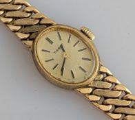 A vintage ladies Tissot manual wristwatch with an oval 9ct gold case and woven design bracelet strap