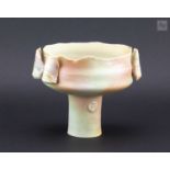 † COLIN PEARSON (1923-2007); a porcelain stem cup with wings covered in celadon glaze with rose pink
