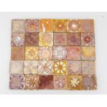 Aldermaston Pottery; a collection of small square tin glazed earthenware glaze test tiles, mostly
