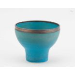 † ABDO NAGI (1941-2001); a porcelain cup covered in turquoise glaze with bronze rim, impressed mark,