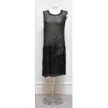 An original 1920s Art Deco black flapper style beaded dress, with a sunburst pattern in sequins