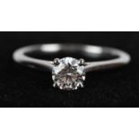 CARTIER; a platinum diamond solitaire ring, the round brilliant cut diamond assessed as 5.68 x 5.