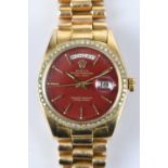 ROLEX; a rare 18ct gold Oyster Perpetual Day-Date wristwatch, with the rare tobacco/oxblood dial set