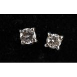 A pair of 18ct white gold diamond ear studs, combined approx 1.01g.
