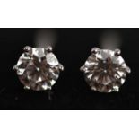 A pair of 18ct white gold diamond solitaire ear studs, with GIA report stating 4.28-4.3-2.67mm,