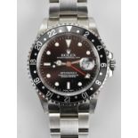 ROLEX; a gentleman's stainless steel GMT-MASTER II, the black face set with subsidiary date