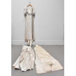 An Edwardian style cream silk satin full length wedding gown, with a wide square shaped decolletage,