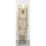 An original Art Deco 1920s evening flapper dress made with gold silk chiffon, embellished with dense