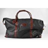 MULBERRY; a large vintage black scotchgrain holdall overnight bag, with dark brown leather handles