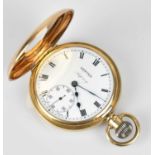 ASPREY; a 9ct yellow gold crown wind half hunter pocket watch, the enamel dial set with Roman