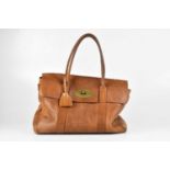 MULBERRY; a tan grained leather Bayswater handbag, with top rolled handles, front brass postman's