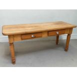 A pine country kitchen style dining table, with two drawers, on turned legs, height 79cm, length