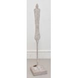 IN THE STYLE OF ALBERTO GIACOMETTI; a concrete figure, signed 'SF', height 127cm.