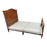 A French carved walnut double bed, with panelled headboard, height 152cm, length 216cm, width
