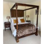 A modern stained pine four poster bed, with turned column supports and block legs, height 202cm,