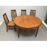 G PLAN; a teak circular extending dining table, height 73cm, width 122cm (extended width