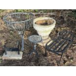 A wrought iron garden planter, height 61cm, with an oval jardiniere stand, a plant stand, a boot