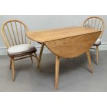 ERCOL; a light elm dining table, height 71cm, length 113cm, with two Ercol chairs (3). Condition