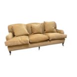GEORGE SMITH; a modern three seater sofa, with golden coloured upholstery, on turned legs with
