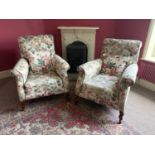 A pair of early 20th century country house wingback library/salon chairs, with floral upholstery, on