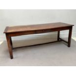 A 19th century and later French farmhouse kitchen table, with a rectangular top above side drawer,