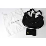 CHRISTIAN DIOR; a black leather handbag with corset lace detail to the edges, strap and catch,