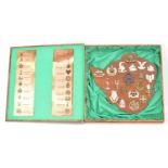 An unusual presentation display set of twenty Rhodesian military cap badges, mounted on a wood cut-
