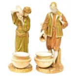 ROYAL WORCESTER; a pair of James Hadley figures of water carriers, these glazed Parian ware
