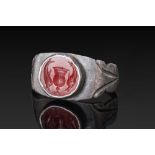 ROMAN CARNELIAN INTAGLIO OF A VASE FLANKED BY DOLPHINS IN SILVER RING