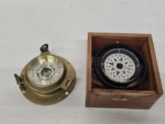 A BRASS PORTHOLE-STYLE ANEROID BAROMETER TOGETHER WITH A PLASTIMO DORIS CARDEN FLAT COMPASS IN A