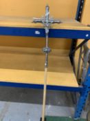 A WHITE METAL PROCESSIONAL CRUCIFIX ON A WOODEN POLE - 164 CM (H)