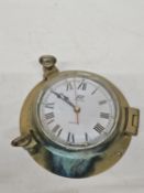 A PLASTIMO SOLID BRASS PORTHOLE-STYLE QUARTZ CLOCK