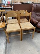 A SET OF FOUR LIGHTWOOD DINING CHAIRS WITH CURVED TOP RAIL AND RUSH SEATS