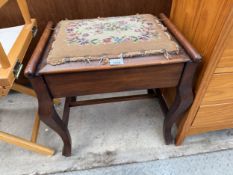 AN EDWARDIAN PIANO STOOL WITH LIFT UP WOOLWORK SEAT