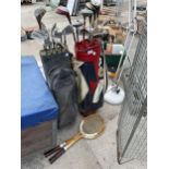 TWO VINTAGE GOLF BAGS WITH AN ASSORTMENT OF CLUBS AND TWO WOODEN TENNIS RACKETS