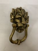 A SOLID BRASS CLASSIC LION HEAD DOOR KNOCKER